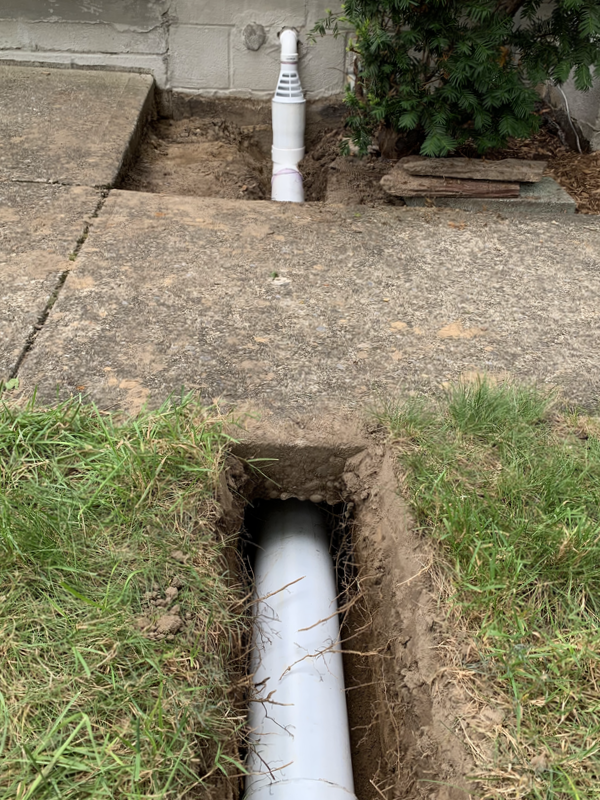 DIY outdoor drainage ideas for a home. How to install drainage for water around the exterior foundation of a house or in the yard. Landscape drainage pictures for installing a french drain, underground downspout pipes, dry well, and catch basins. 