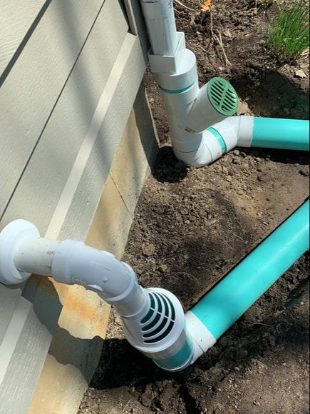 Water drainage solutions for around the outside of a home. DIY drainage system ideas for a french drain, dry well, underground gutter downspout, yard catch basins, sump pump discharge, foundation waterproofing, and standing water issues.