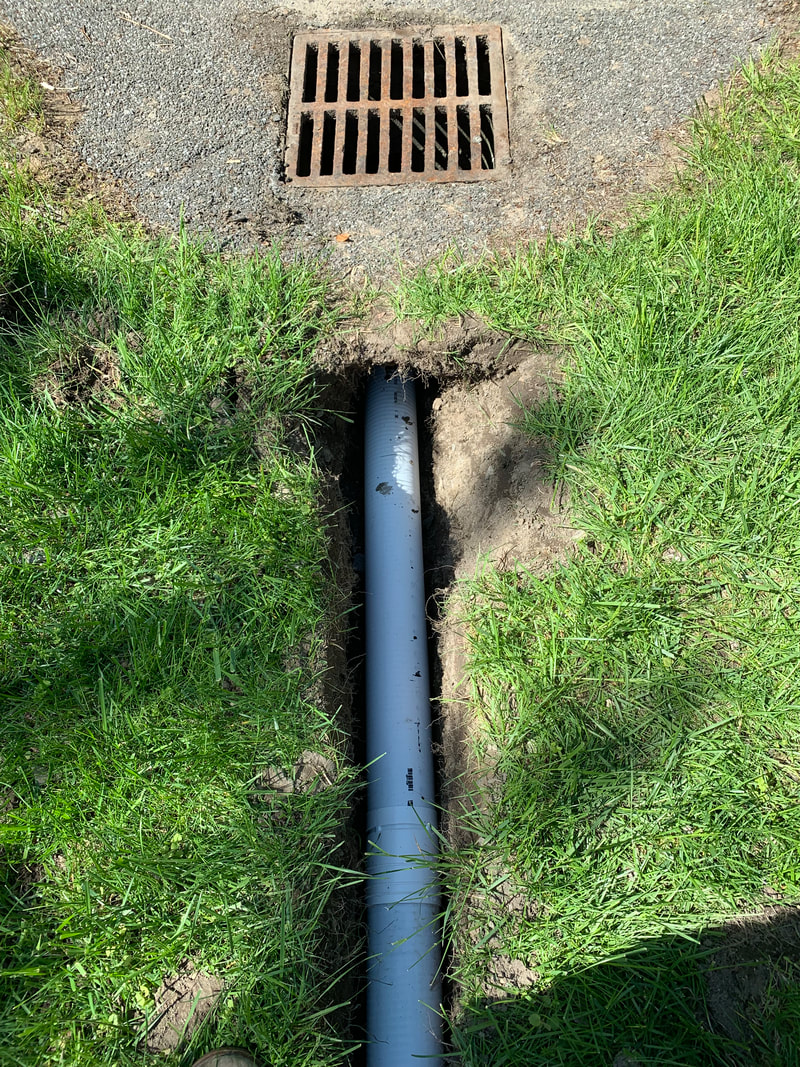 How to install underground drainage system pictures for the exterior of a house, in the yard, and through landscape beds. Water drainage solutions around the outside of a home. DIY landscaping, plumbing, and exterior basement waterproofing ideas. 