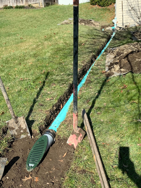How to install drainage outside a house pictures. DIY drainage system ideas for a french drain, dry well, underground downspout, sump pump discharge, catch basin, gutter water, landscape beds, foundation repair, and standing water issues in a yard.