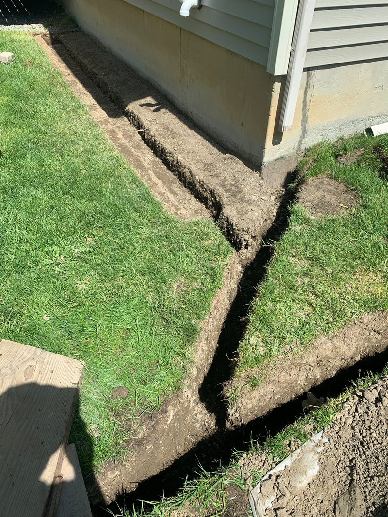 How to install underground drainage system pictures for the exterior of a house, in the yard, and through landscape beds. Water drainage solutions around the outside of a home. DIY landscaping, plumbing, and exterior basement waterproofing ideas. 