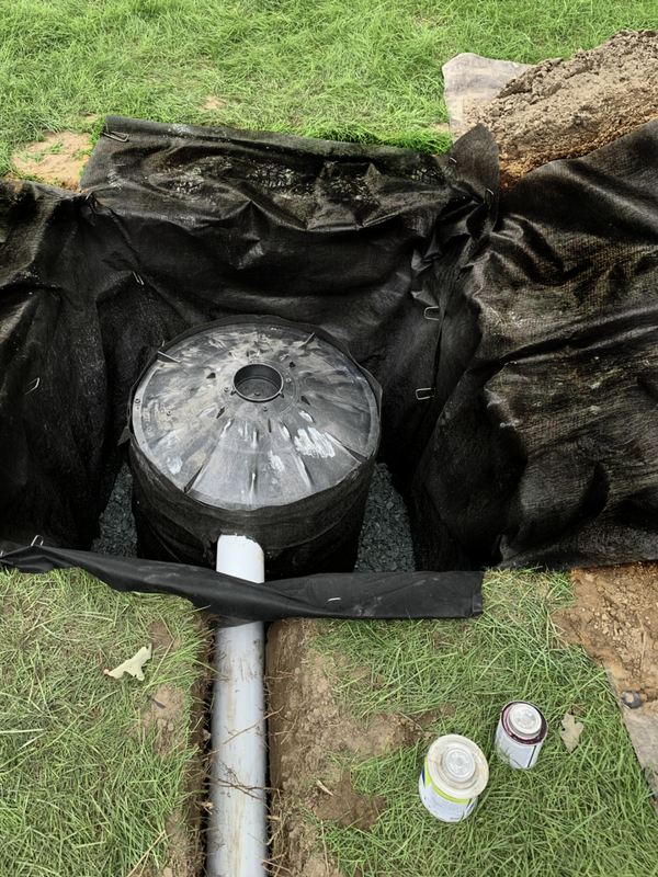 DIY drainage solutions for the outside of a home, landscape, and yard. How to install drainage ideas for a french drain, catch basin, dry well, underground downspout pipe, sump pump discharge, gutter water, and exterior foundation drains.